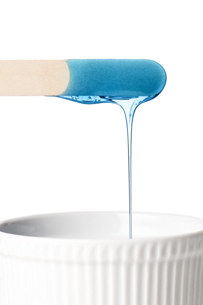blue wax dripping off a popsicle stick